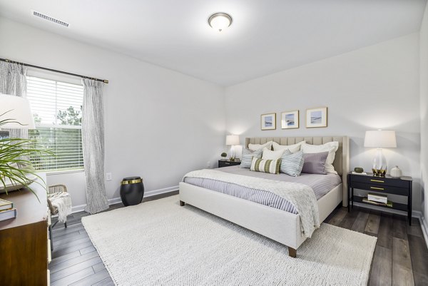 Cozy bedroom featuring modern decor at Abode at Geneva Apartment Townhomes, luxury living in a tranquil setting