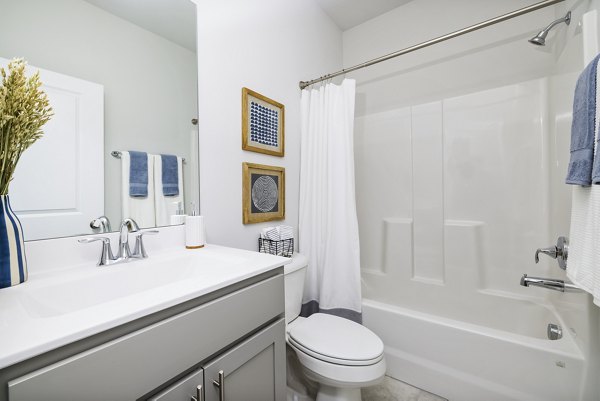 Spacious bathroom with elegant fixtures in Abode at Geneva Apartment Townhomes