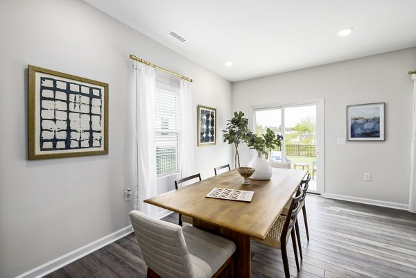 Dining room featuring sleek modern furniture in Abode at Geneva Apartment Townhomes