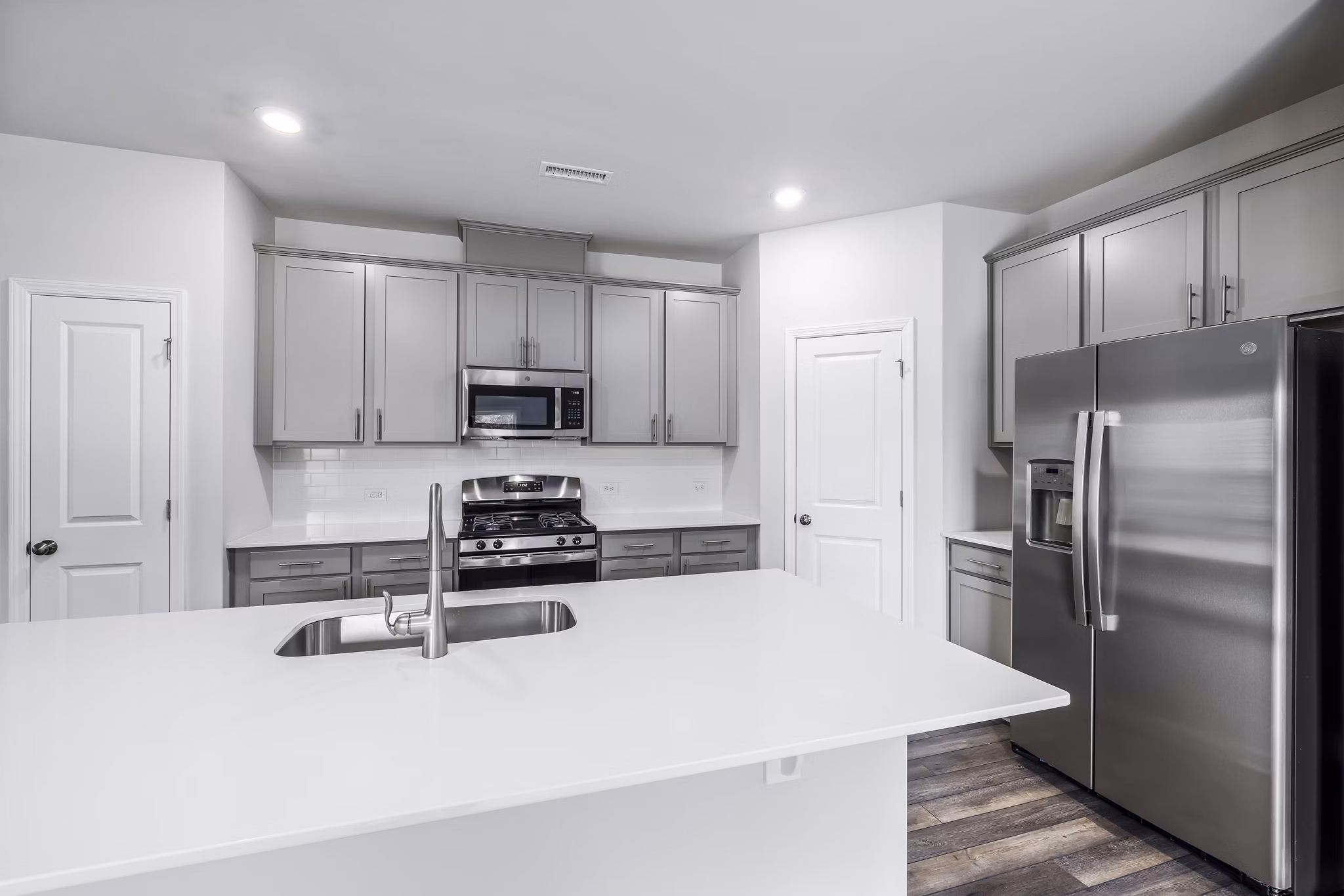 Modern kitchen with stainless steel appliances at Abode at Geneva Apartment Townhomes