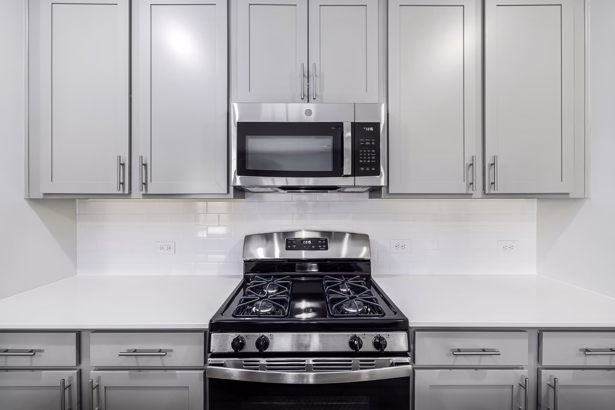 Modern kitchen with sleek countertops and stainless appliances at Abode at Geneva Apartment Townhomes