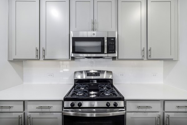 Modern kitchen with sleek countertops and stainless appliances at Abode at Geneva Apartment Townhomes