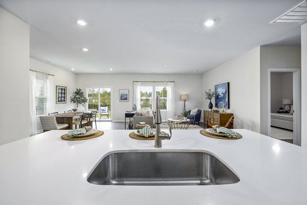Modern kitchen with stainless steel appliances at Abode at Geneva Apartment Townhomes