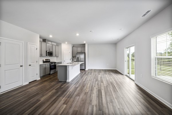 Spacious living room featuring modern furnishings at Abode at Geneva Apartment Townhomes