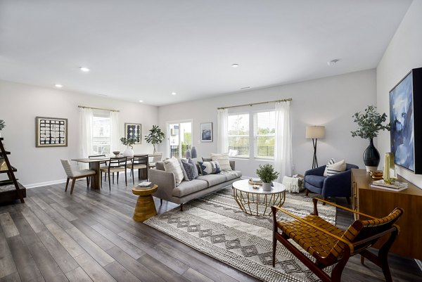 Modern living room with stylish decor at Abode at Geneva Apartment Townhomes, offering a luxurious space for relaxation and entertaining