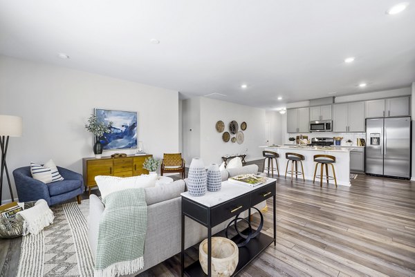 Modern living room with stylish furnishings at Abode at Geneva Apartment Townhomes, showcasing a cozy yet elegant ambiance