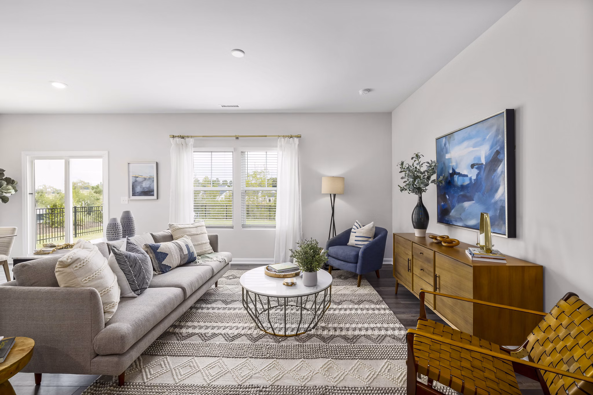 Spacious living room with elegant decor in Abode at Geneva Apartment Townhomes, featuring a cozy seating area and large windows