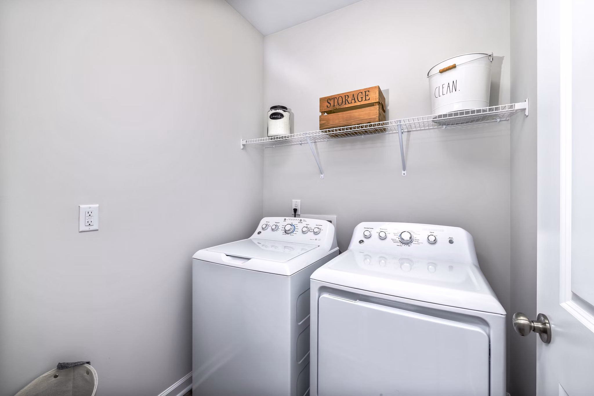Laundry room featuring modern washers and dryers in Abode at Geneva Apartment Townhomes
