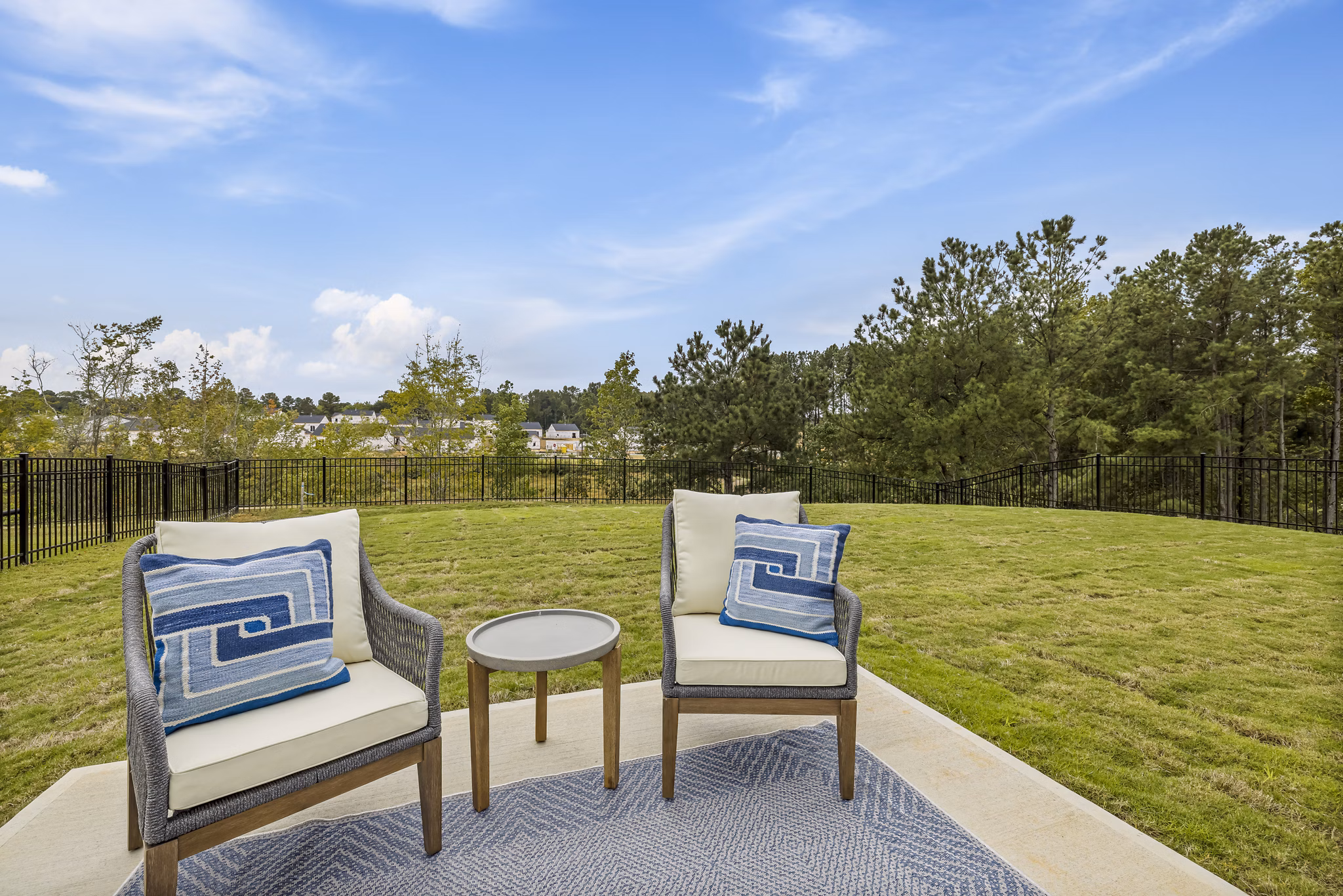 Spacious backyard patio with modern seating at Abode at Geneva Apartment Townhomes, perfect for outdoor relaxation and gatherings