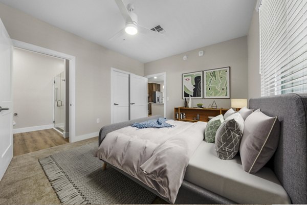 Spacious bedroom with modern decor at Album Cooley Station Apartments, featuring stylish design and comfort for luxury living