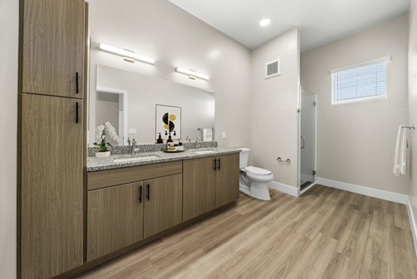 Elegant bathroom with marble countertops at Album Cooley Station Apartments, featuring modern fixtures and spacious layout