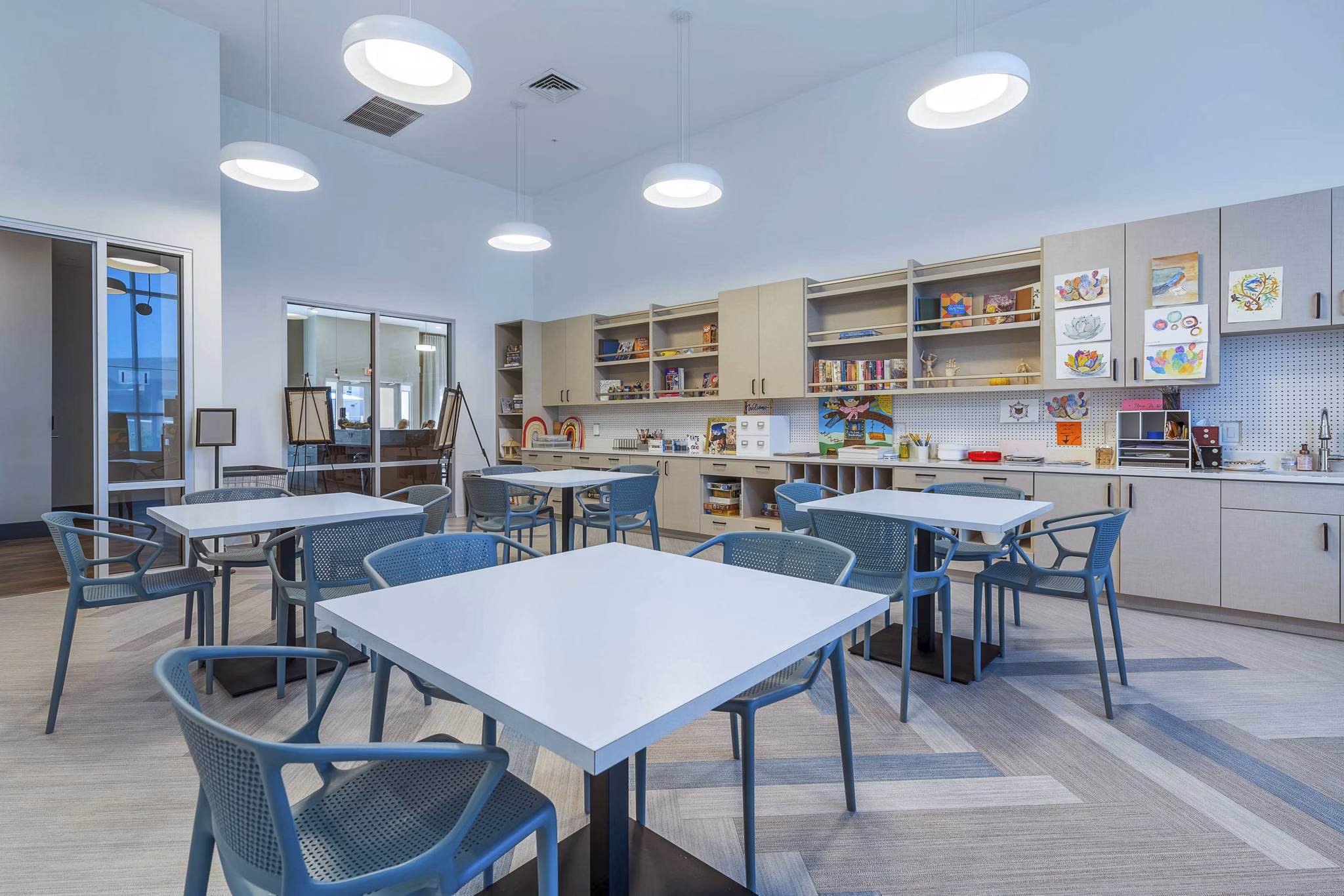 Clubhouse with modern decor and seating at Album Cooley Station Apartments, offering a luxury living experience in Greystar's portfolio