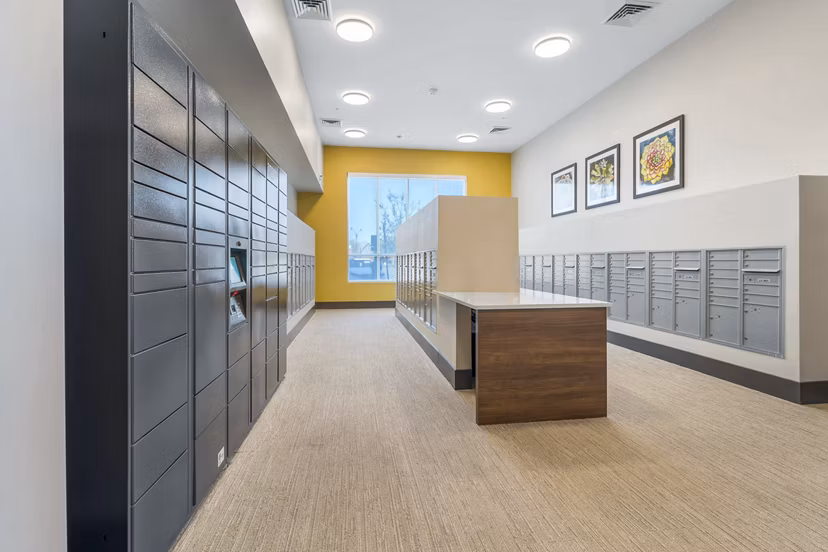 Mail room with parcel pickup lockers at Album Cooley Station, a luxury Greystar apartment community