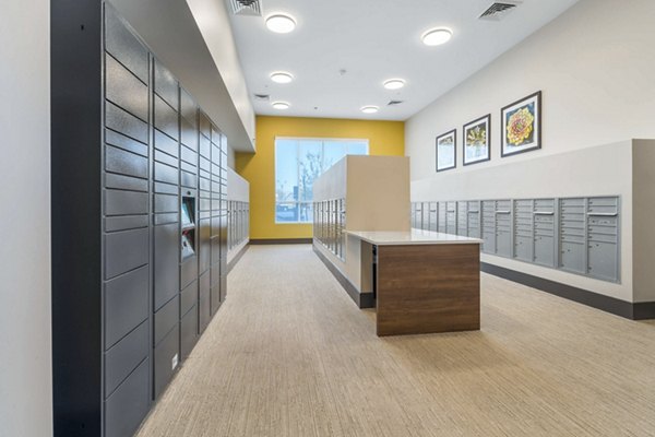 Mail room with parcel pickup lockers at Album Cooley Station, a luxury Greystar apartment community