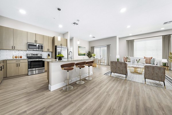 Sleek kitchen with modern appliances and island at Album Cooley Station Apartments