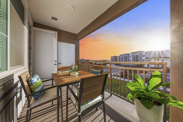 Private patio with stylish furnishings at Album Cooley Station Apartments