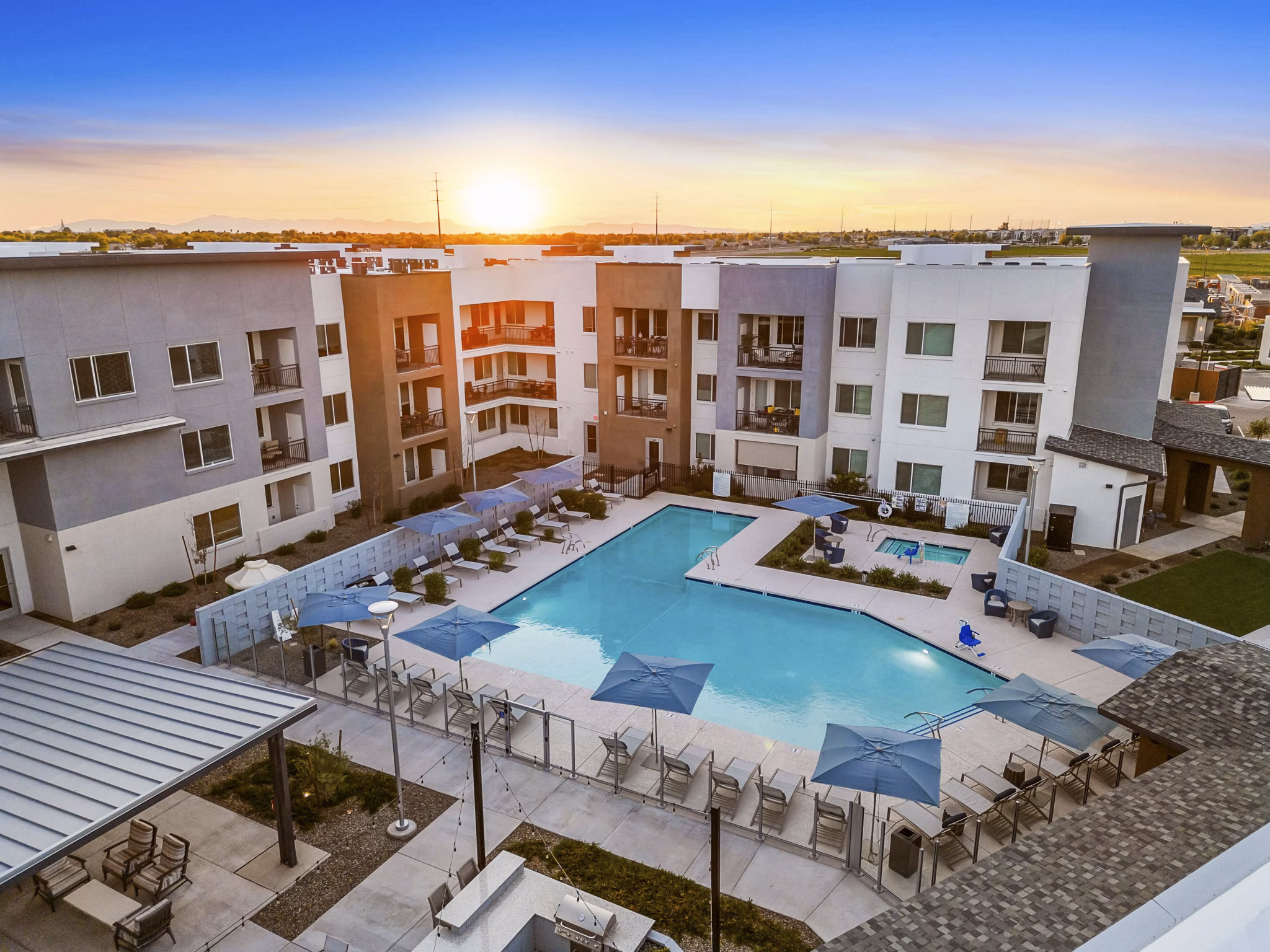 Resort-style pool with lounge chairs at Album Cooley Station Apartments offering luxury living in a serene environment