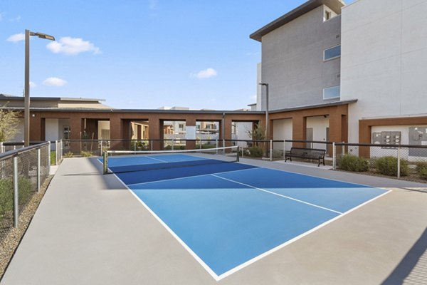 Outdoor tennis court at Album Cooley Station Apartments offering well-maintained facilities for active living in a vibrant community setting