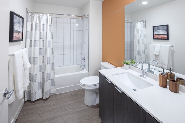 Bathroom featuring modern design elements at Sawbuck Apartments