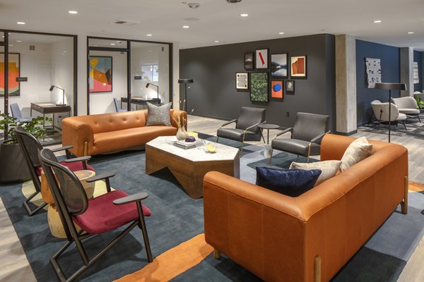 Clubhouse with cozy seating and billiards table at Sawbuck Apartments, perfect for social gatherings and relaxation