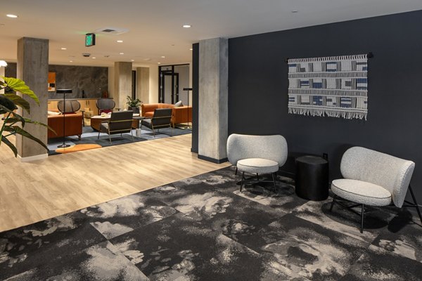 Clubhouse with modern decor and seating areas at Sawbuck Apartments, offering residents a luxury gathering space for social events and relaxation