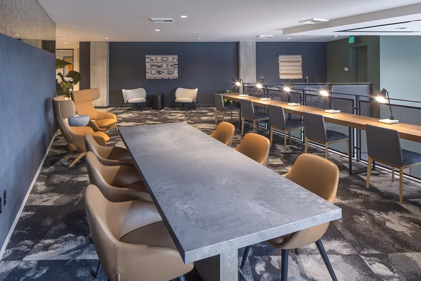 Meeting facility with modern seating and conference setup at Sawbuck Apartments, ideal for hosting events and collaborative workspaces