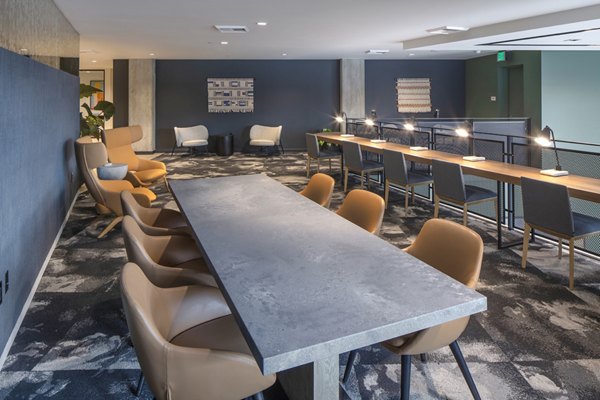 Meeting facility with modern seating and conference setup at Sawbuck Apartments, ideal for hosting events and collaborative workspaces