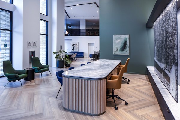 Welcome lounge with modern seating and decor at Sawbuck Apartments clubhouse