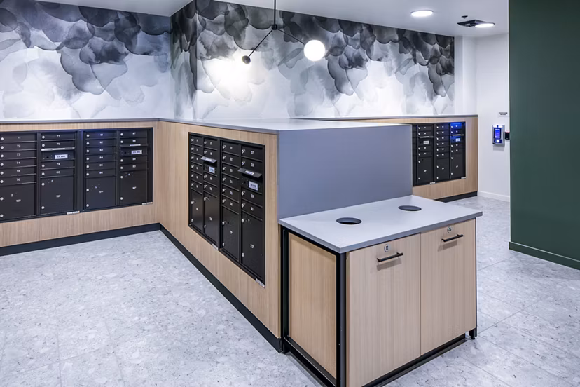 Mailroom with organized parcel lockers at Sawbuck Apartments