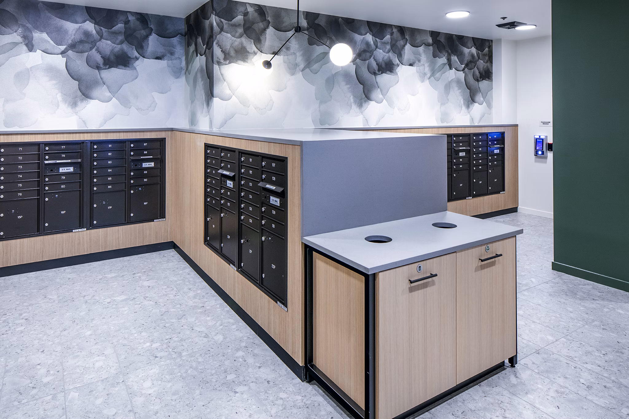 Mailroom with organized parcel lockers at Sawbuck Apartments