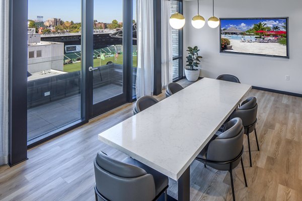 Clubhouse kitchen with modern appliances and island seating at Sawbuck Apartments