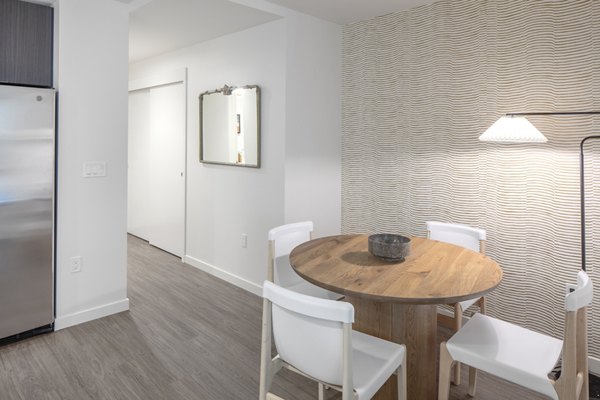 Sawbuck Apartments: Modern dining area with stylish seating and elegant lighting, ideal for luxury living