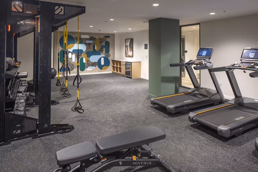 State-of-the-art fitness center with modern equipment at Sawbuck Apartments, offering residents an active lifestyle experience