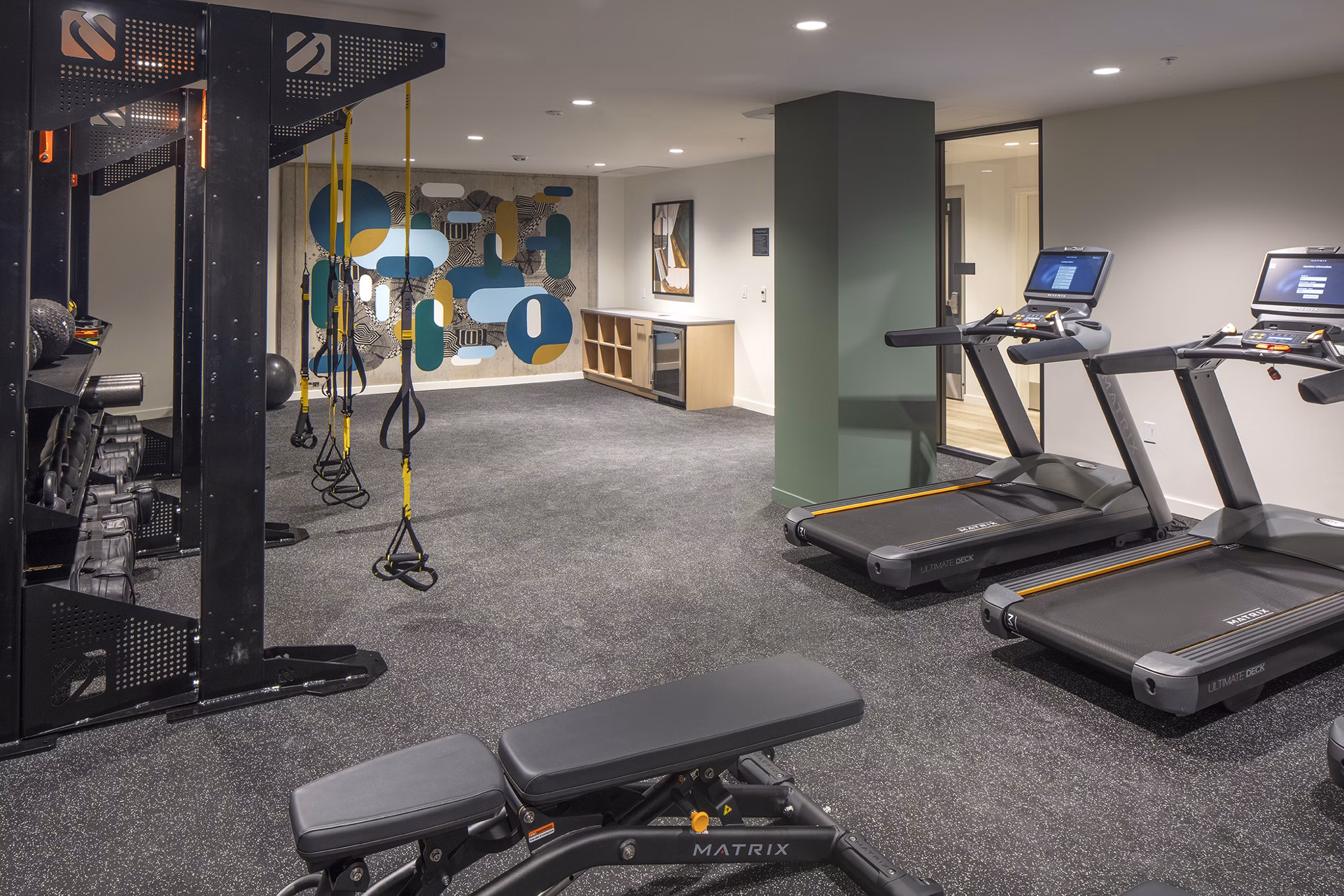 State-of-the-art fitness center with modern equipment at Sawbuck Apartments, offering residents an active lifestyle experience