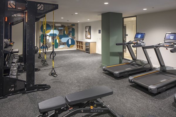 State-of-the-art fitness center with modern equipment at Sawbuck Apartments, offering residents an active lifestyle experience