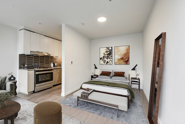 Modern kitchen with stainless steel appliances in Sawbuck Apartments