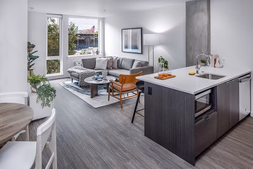 Modern kitchen featuring stainless steel appliances and granite countertops at Sawbuck Apartments Luxury living in a premier Greystar property
