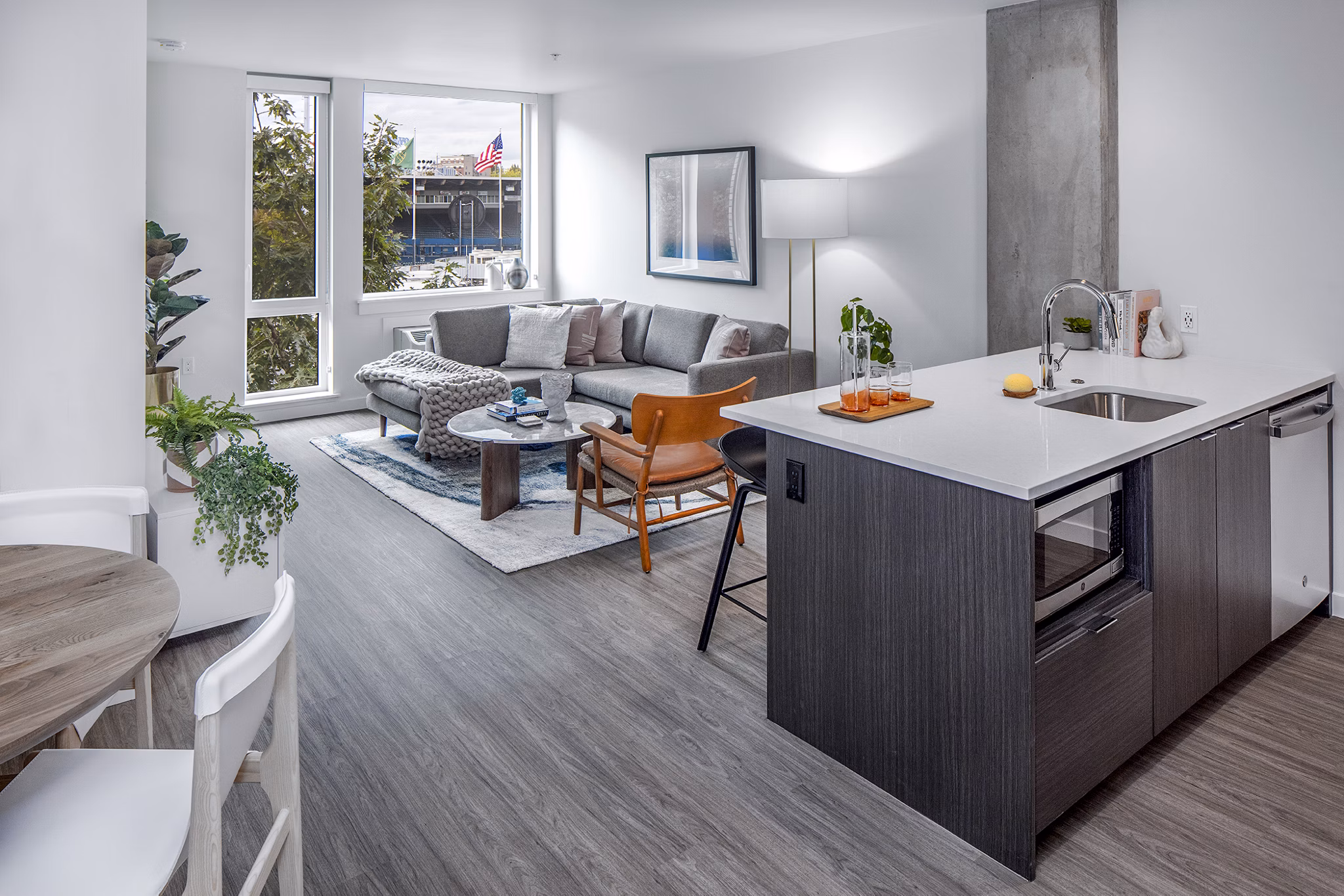 Modern kitchen featuring stainless steel appliances and granite countertops at Sawbuck Apartments Luxury living in a premier Greystar property