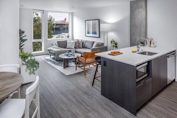 Modern kitchen featuring stainless steel appliances and granite countertops at Sawbuck Apartments Luxury living in a premier Greystar property