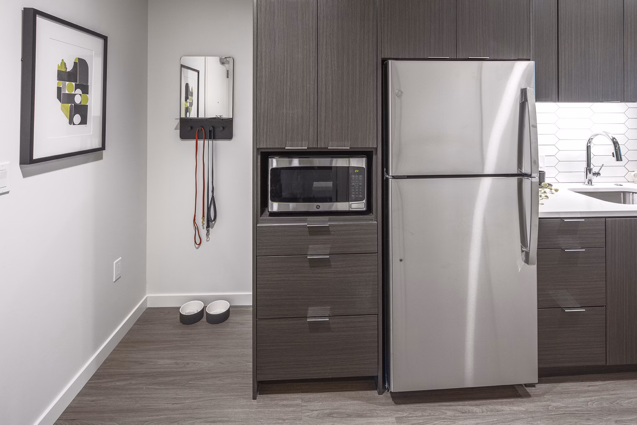 Modern kitchen with stainless steel appliances in Sawbuck Apartments, a luxury Greystar property