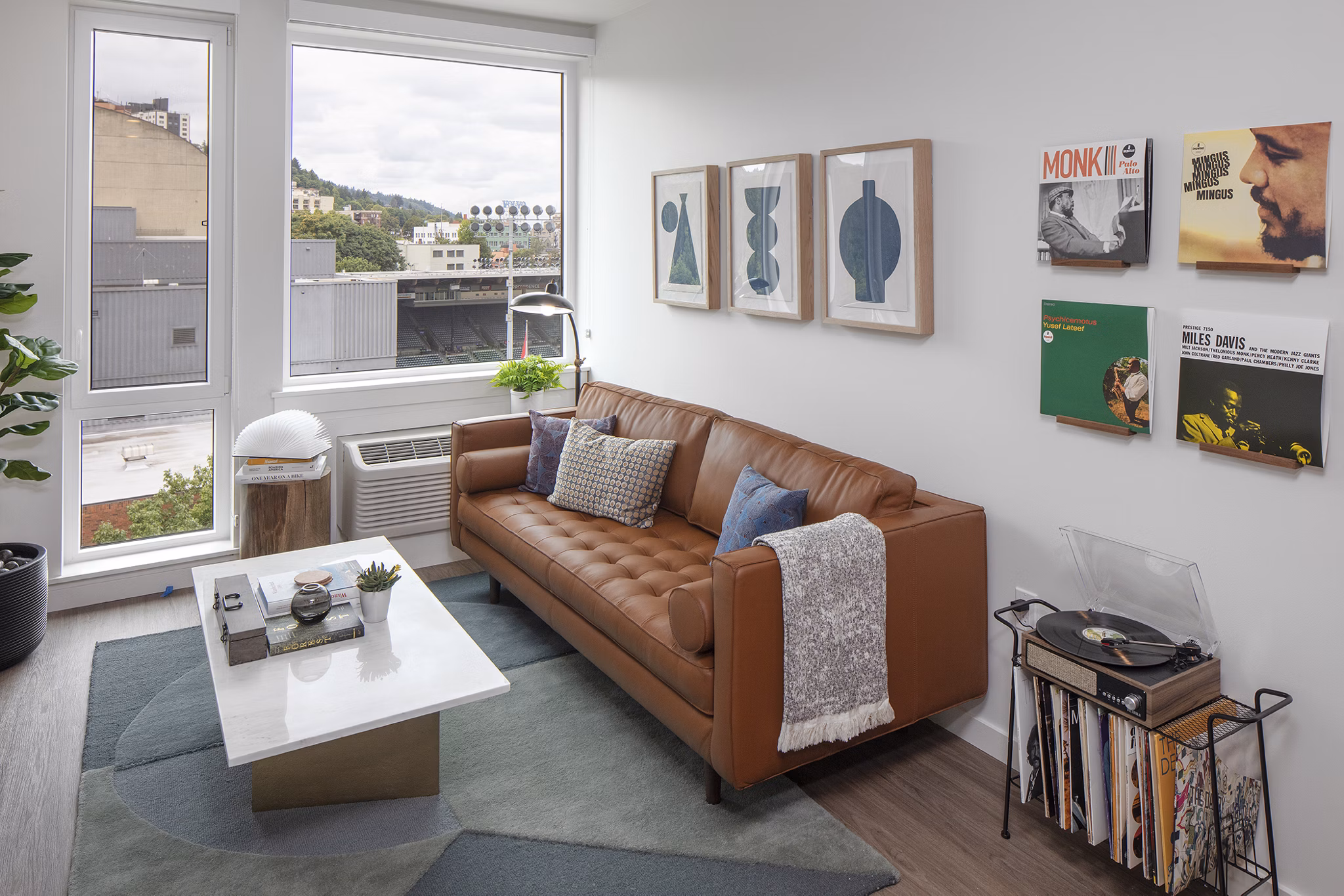 Modern living room with sleek decor and ample natural light at Sawbuck Apartments, showcasing luxury living in a Greystar community