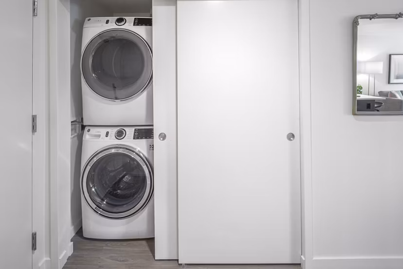 Laundry room featuring state-of-the-art washers and dryers at Sawbuck Apartments