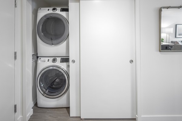 Laundry room featuring state-of-the-art washers and dryers at Sawbuck Apartments