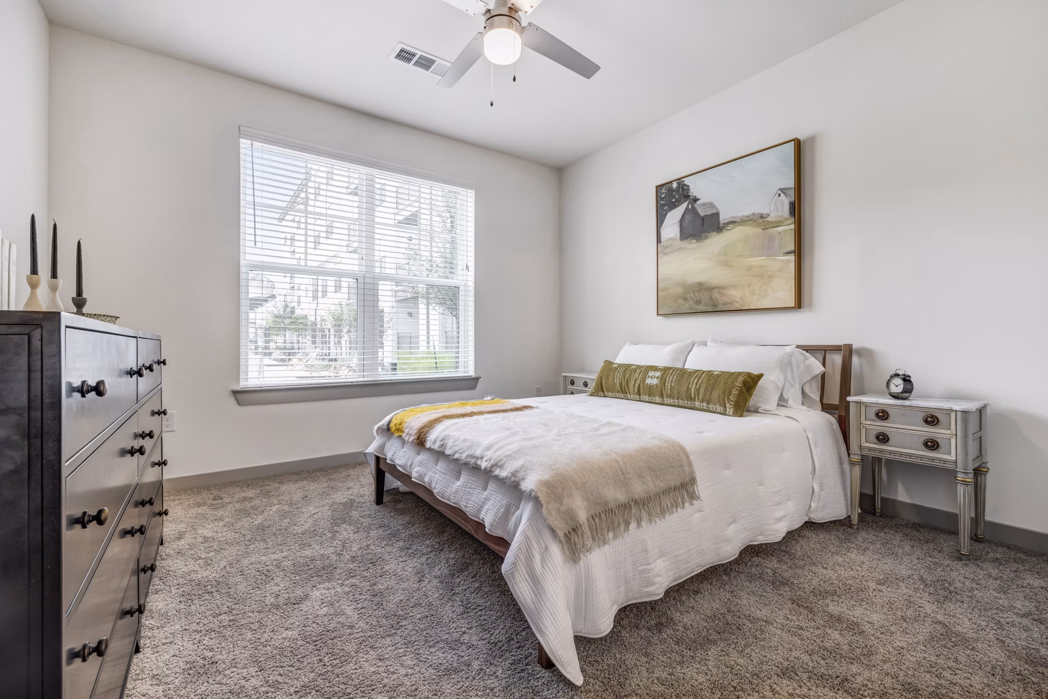 Cozy bedroom with modern furnishings at Laurel Apartment Homes in Greystar luxury apartments