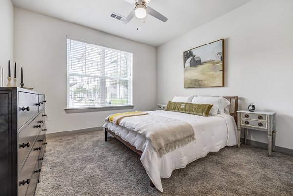 Cozy bedroom with modern furnishings at Laurel Apartment Homes in Greystar luxury apartments