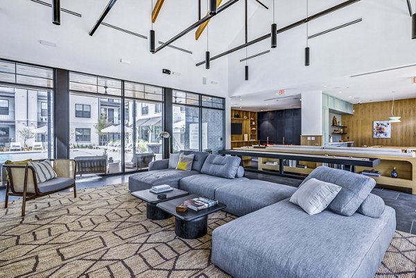 Modern game room with pool table and seating at Laurel Apartment Homes