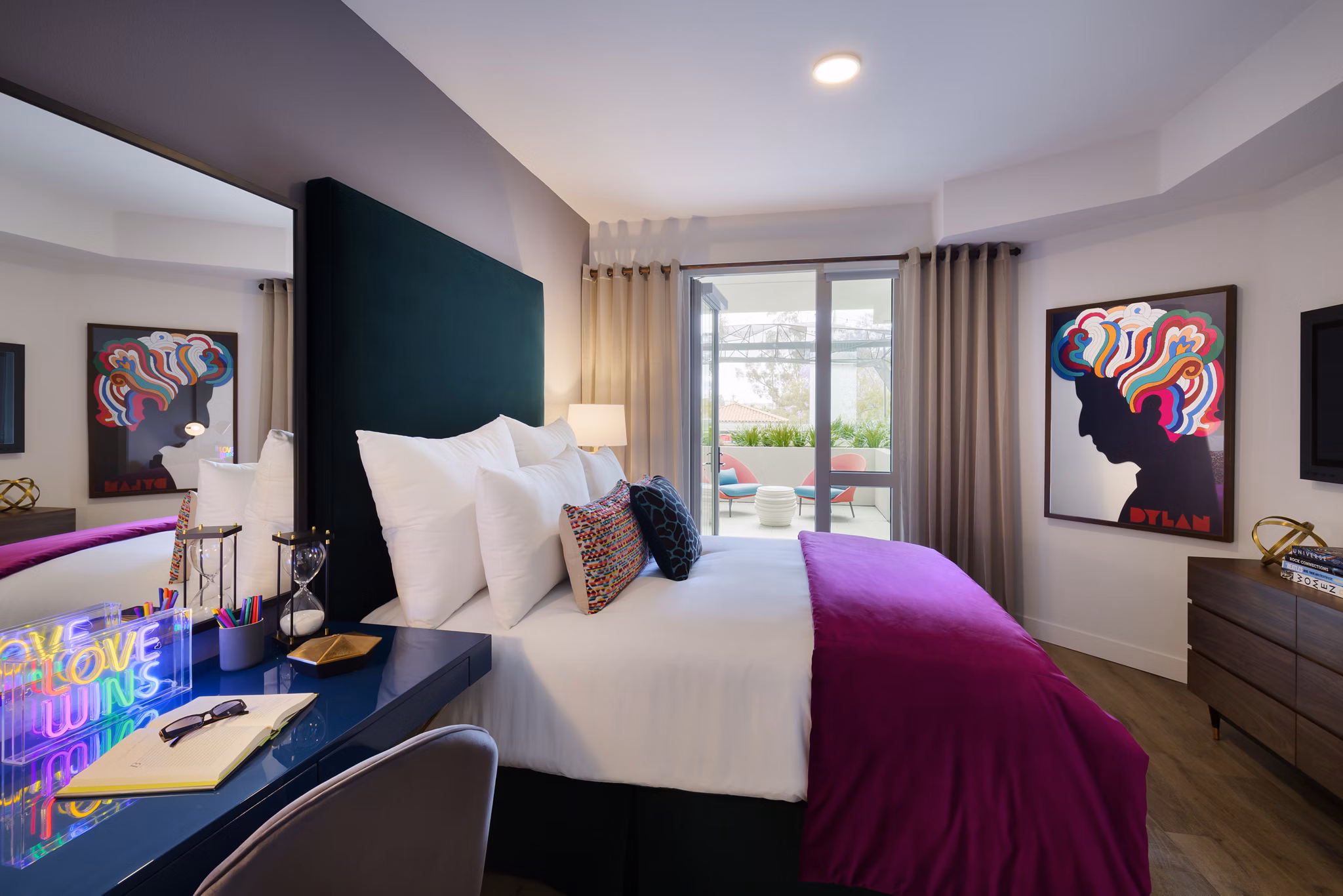 Cozy bedroom featuring modern decor and ample natural light at Mode Apartments