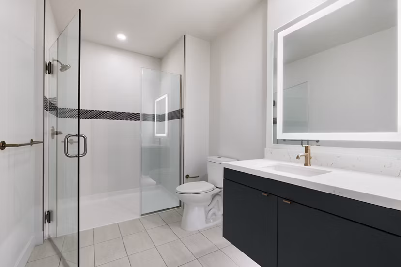 Luxurious bathroom featuring dual vanities and modern fixtures at Mode Apartments in central location