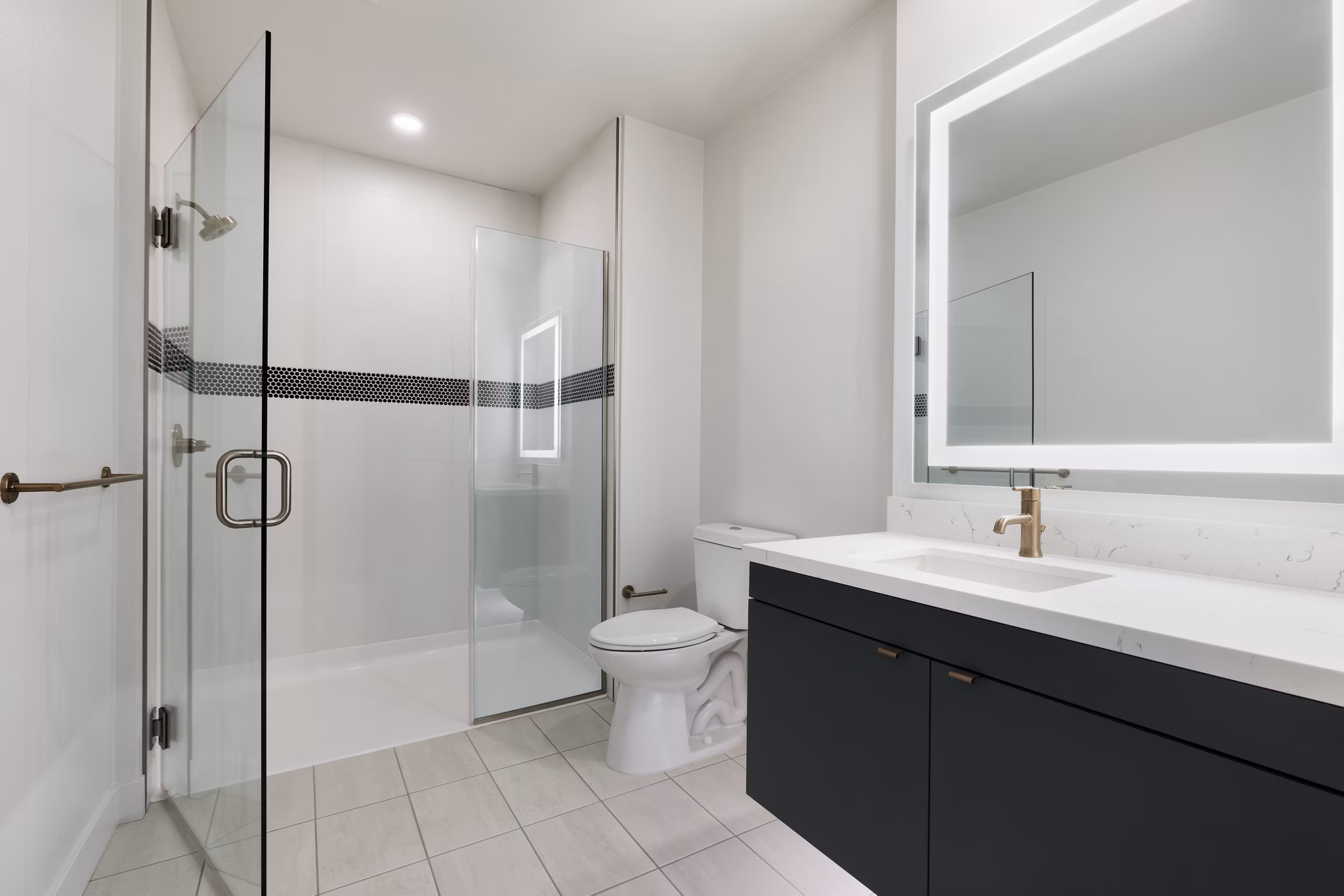 Luxurious bathroom featuring dual vanities and modern fixtures at Mode Apartments in central location