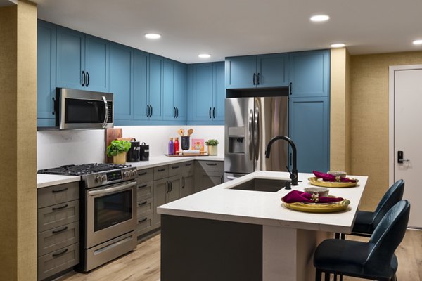 Modern kitchen with stainless steel appliances at Mode Apartments